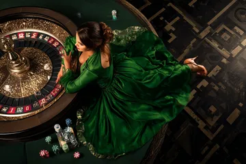 A cheerful woman in traditional clothing using her smartphone during a festive moment, showing how easily the CROWNBD app fits into everyday life.