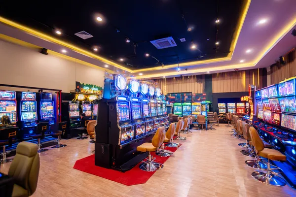 A glamorous woman holding casino chips in a neon-lit environment, representing the premium online casino atmosphere of CROWNBD.