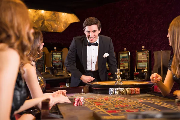 A stylish woman beside vibrant slot machines displaying glowing sevens, showcasing the variety of top slots at CROWNBD.