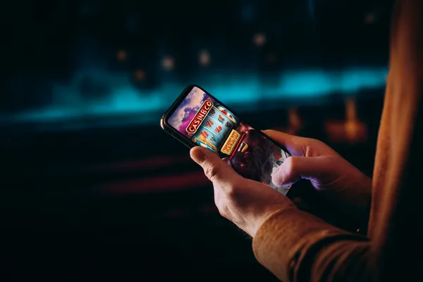 A close-up shot of golden coins falling around a spinning roulette wheel, representing immersive casino action at CROWNBD.
